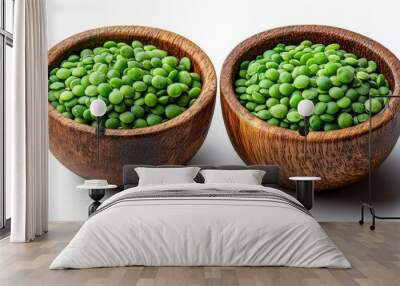 Two wooden bowls filled with green peas. The bowls are placed on a white background. The peas are spread out in the bowls, creating a sense of abundance and freshness Wall mural