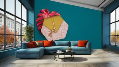 Glamorous women's handbag and bright monstera leaf. Women's accessories for shopping, storing money and cosmetics. Fashionable elegant style. The minimum concept of fashion. Top view, copy space. Wall mural