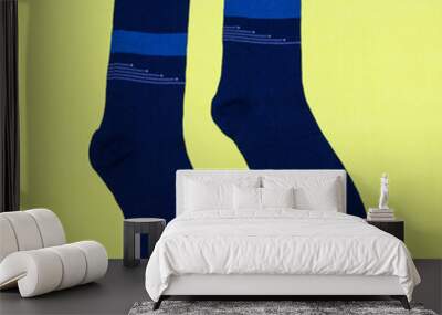 A pair of men's blue socks on a yellow background Wall mural