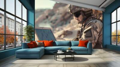 A laptop computer is used by soldiers during military operations in the desert for surveillance. Wall mural