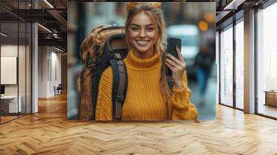 A smiling young woman walks with a suitcase and talks on the phone Wall mural