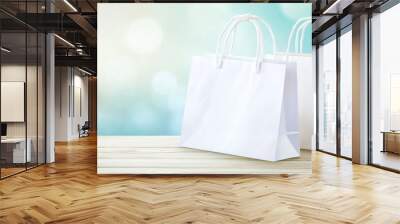 A soft, out-of-focus background combines simplicity and minimalism in two empty white shopping bags. Wall mural