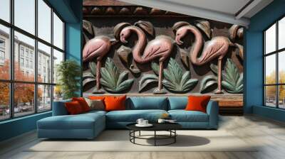 Against a leafy background, two flamingos stand Wall mural