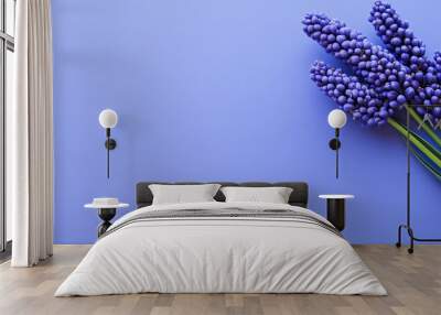 Against a lush purple background, a vibrant purple flower stands out beautifully. Wall mural