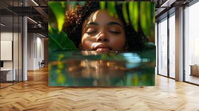 An exotic black african-american girl emerges from pound water with lush vegetation and beautiful lighting to reveal the details of her face in this luxurious setting Wall mural