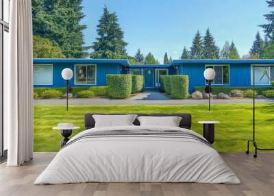 An exterior photo of a luxury house with craftsman style windows, a landscaped lot and a vaulted entry shows a blue sky and green foliage. Wall mural