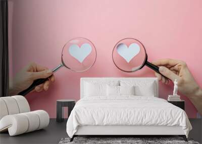 An image of two magnifying glasses with a female hand holding a paper heart and a doctor's hand holding a paper heart. The image represents dating, consultation, and seeking medical assistance. Wall mural