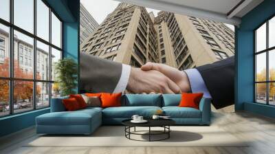 Handshake close-up in city building Wall mural