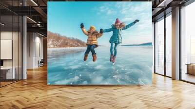 Having fun in the snow on a sunny winter day with two happy girls Wall mural