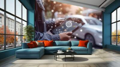 Image of an aman holding a tablet and holding a car icon. A logistics concept for goods and cargo delivery. Wall mural