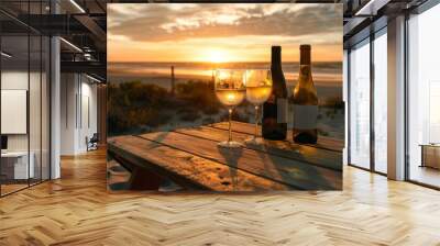 In this close-up shot, a couple wine champagne glasses and bottle are for celebration on wooden table against the background of sea views and sunset skies, over a chilling day at the ocean, with Wall mural