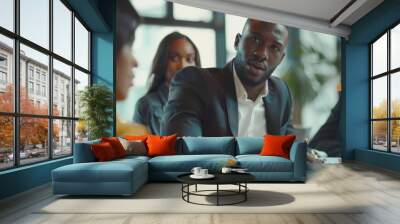 Meeting of a diverse team of professional businesspeople in an office conference room. Black Businesswoman, African-American Digital Entrepreneur, and Hispanic CEO in conversation. Wall mural