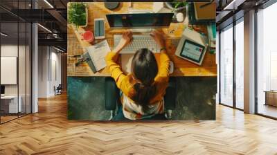 Picture of a female office worker using a desktop computer, a project manager stands beside and offers advice on optimizing workflow. Wall mural