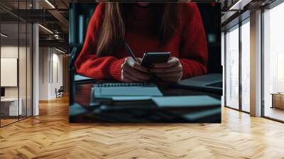 Planner on mobile phone, schedule on calendar planner, laptop computer on desk. Businesswoman checking planner on mobile phone, scheduling on calendar planner. Wall mural