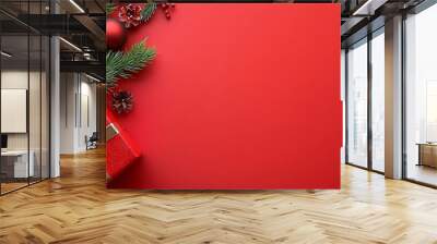 The border of this Christmas decoration is made up of fir branches on a red background. Wall mural