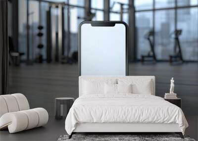 The interior of a modern gym features a smartphone with a blank screen. Wall mural