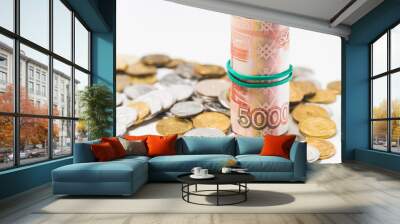 five thousand dollar bills and coins on a white background Wall mural