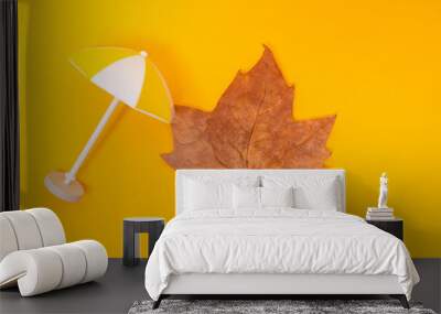 green leaf and beach umbrella on yellow background Wall mural