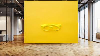 yellow glasses on a yellow background Wall mural