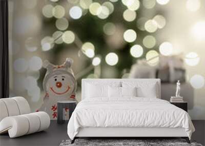 Ceramic snowman with a white car on the background of a Christmas tree Wall mural