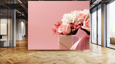 a bouquet of flowers and a gift on a pink background.Generative AI Wall mural