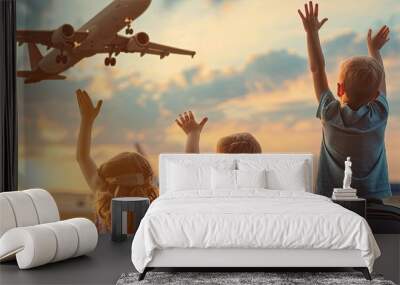 children are waving at the plane. Selective focus Wall mural