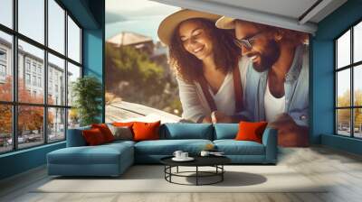 Fun, friends, travel and tourism concept. a beautiful couple is looking for a way on a map Wall mural