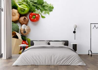 Healthy food in a paper bag of vegetables and fruits on white. Wall mural