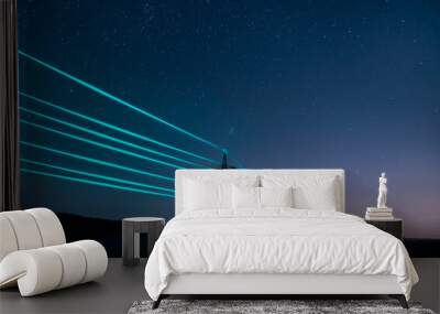 Electricity transmission towers with glowing wires against the starry sky. Energy concept. Wall mural