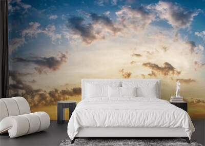 Panorama of dramatic sky with clouds at yellow-orange sunset. Wall mural