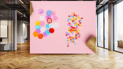 large and small buttons with threads on a pink background Wall mural