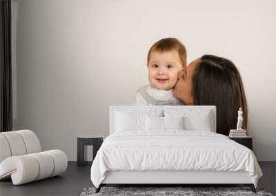 Happy young mother with her baby, little son in love on white background copy space. The concept of a happy family, motherhood. mother and child portrait Wall mural