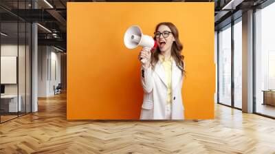 business girl in glasses and suit announces information into megaphone, manager in office style shouts into loudspeaker Wall mural