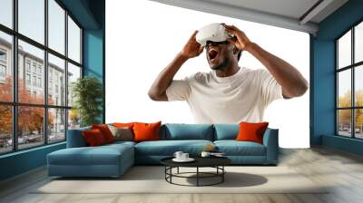 shocked african american man in white t-shirt plays video games in virtual reality glasses and shouts Wall mural