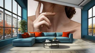 Beauty portrait of chestnut-haired girl with long neck and distinctive collar bones, long graceful fingers touching chin and piebald skin Wall mural