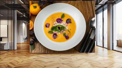 Tomato puree soup with yellow tomatoes on a wooden table
 Wall mural