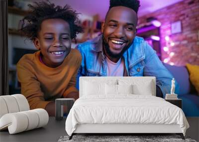 Happy father and son playing video game on sofa Wall mural