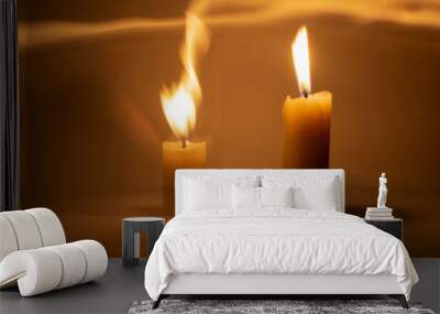 Photo of a burning candle with a yellow flame	 Wall mural