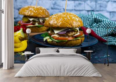 Two homemade beef burgers with mushrooms, micro greens, red onion on wooden cutting board Wall mural