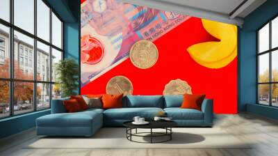 Ten Hong Kong dollar bill, gold dollar coins and chinese fortune cookie on red background. Money and Fortune Wall mural