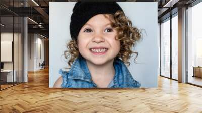 portrait of a beautiful, curly-haired girl who smiles Wall mural