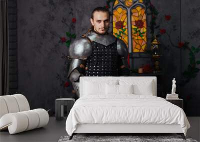 Portrait of a medieval knight with a two-handed sword. Warrior in the studio on a dark background. Wall mural