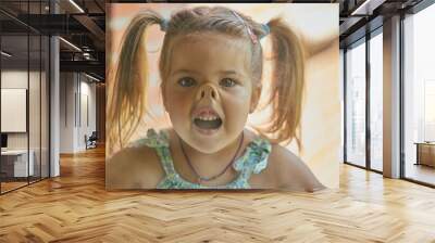 charming child fooling around with his face pressed against the glass Wall mural