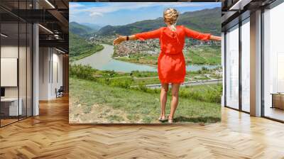 A girl on the background of a view of the Mtkvari River flowing into the Aragvi River. Mtskheta Georgia 2019 Wall mural