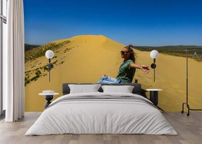 A girl on the sand dunes of Sarykum. The desert in Dagestan. Russia. 2021. Wall mural