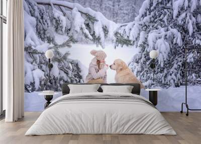 beautiful girl with golden retriever dog in snowing forest Wall mural