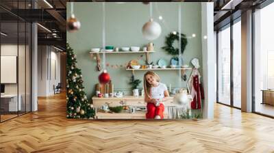 Cute little girl with christmas present at home Wall mural