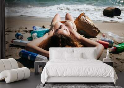 girl lies on the beach among plastic Wall mural