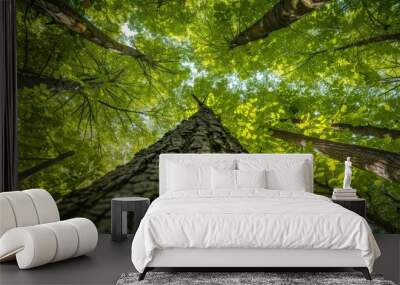 A Canopy Of Lush Green Leaves Encircles A Towering Tree Trunk In A Vibrant Forest Wall mural