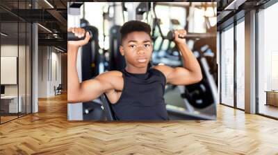 African american teenager trains in gym for health Wall mural